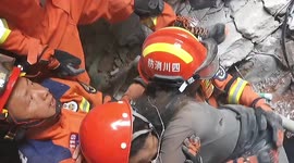 China earthquake: Firefighters pull woman from rubble of collapsed hotel