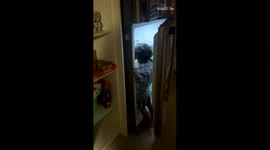 Little soda lover curbs his desire and stops himself from drinking coke