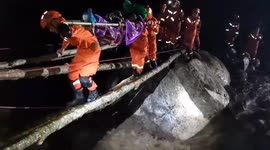China earthquake: Firefighters transport injured across bridge made from tree trunks