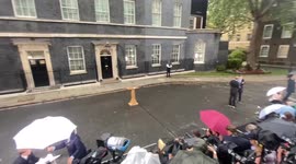 Lectern pulled as Liz Truss arrival at 10 Downing interrupted by heavy rain