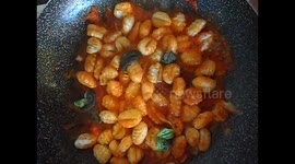 Italian pasta cooks in a pan