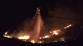 Aircraft drops water loads at night to fight huge fire in Southern California
