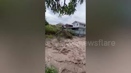Flash floods wash away trees from outside homes in southern Thailand