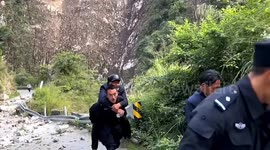 Police officers carry elderly residents on backs after earthquake hits southern China