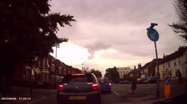 DASHCAM - UBER Taxi Driver drives on wrong side of road, around KEEP LEFT traffic island) to turn right.