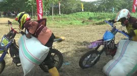 Indonesian farmers compete in motorbike racing carrying sacks of rice