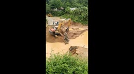 Excavator used to carry locals after flash floods destroy bridge in Vietnam