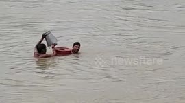 Locals collect sand from river risking bridge collapse in central India
