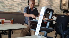 Malaysian restaurant employee robot waiters to deliver food to diners