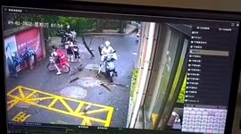Tree branch lands inches away from passing motorcyclist in China