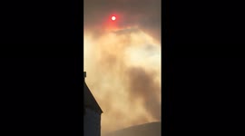 Landscape engulfed by grey and orange clouds as fire breaks out in Turkey