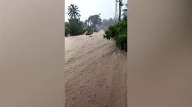 Raging floods surge through street as officials make flood warnings for Bangkok