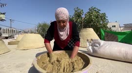 A Palestinian woman Amna Salah prepares the clay ovens to earn livelihood, in the West bank city of Bethlehem