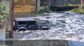 Car driving through flooded roads of Bangalore, India