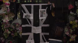 Candles, flags and thousands of flowers left outside Buckingham Palace by the public following Queen Elizabeth II's death