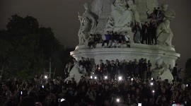 Phones light up the scene in front of Buckingham Palace while mourners sing 'God Save the Queen'