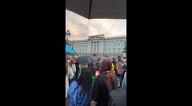 People singing 'God Save the Queen' at Bukhingham palace in London, UK