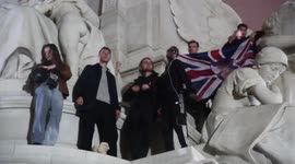 Youths climb up Victoria Memorial outside Buckingham Palace to take selfies after death of queen