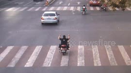 Seven-year-old rides scooter with dad on the back seat during rush hour