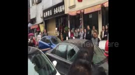 Wife smashes car with her husband and alleged lover inside