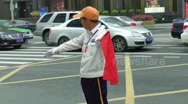 Energetic Chinese traffic warden in action