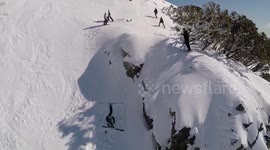 Man attempts switch 180 on skis... fails!