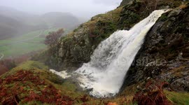 Huge waterfalls as rain drains off Lakeland Fells, UK