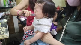 Every parent will relate to this footage of a screaming toddler getting her hair cut
