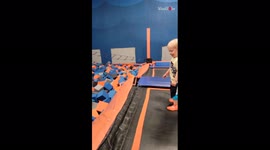 Toddler tries to flip into the foam pit at trampoline park; BOTCHES IT!