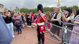 Old man dressed as Queen's guard pays his tribute outside Buckingham Palace