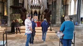 Public say prayers and light candles for Her Majesty Queen Elizabeth II at Salisbury Cathedral .