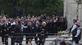 King Charles III and Queen Consort Camilla inspects floral tributes to Queen Elizabeth II outside Buckingham Palace