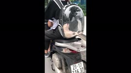 Adorable puppy was spotted dozing in a strange position inside a see-through backpack on the street in Vietnam
