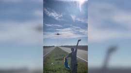 Ukrainian fighter jet roars past cars on rural road amid conflict with Russia