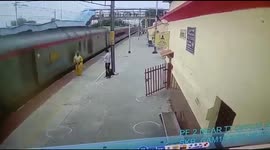 Indian railway officials save Woman crossing Platform in nick time in Northern India.