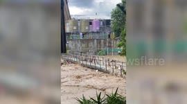 Footbridge washed away by raging river as Typhoon Inday brings rain in the Philippines