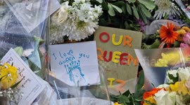 Floral tributes amid the crowds at Buckingham Palace on Saturday