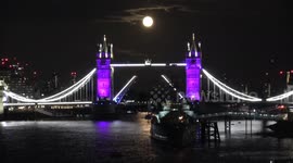 Full moon rises over Tower Bridge as it glows purple to honour Queen