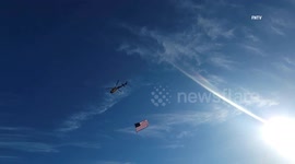 Helicopter with American Flag flies along Hammock Beach in Florida on Anniversary of 9/11 Attacks