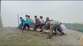Brave officers sit on 17-feet-long crocodile before releasing it: the animal terrorised village for ten days