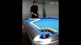 Man proficiently plays a difficult billiard trick shot
