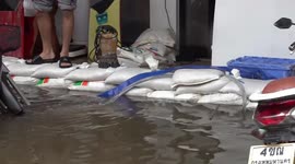 Homes flooded as officials open rescue shelters for stricken residents in Bangkok, Thailand