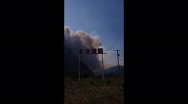 Helicopter soars over the Esso gas station in hope to fight wildfire
