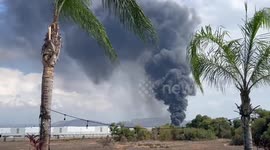 Smoke rises from warehouse fire burning near March Air Reserve Base in California