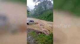 Pickup truck stuck in overflowing river after Typhoon Hinnamnor rain in the Philippines