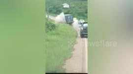 Dramatic moment 'overloaded' truck slides down hill before plunging into ditch in Indonesia