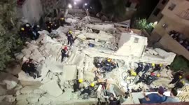 Rescuers work in rubble of building that collapsed in Amman, Jordan