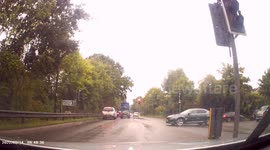 DASHCAM - Impatient and Reckless Driver drives on WRONG SIDE OF ROAD, past KEEP LEFT ISLAND at traffic light junction
