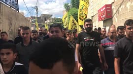 Palestinian fighters and civilians march in the village of Kafr Dan, to show solidarity with the families of 2 Palestinians killed in overnight clashes with Israeli security forces near a checkpoint inorth of the West Bank town of Jenin