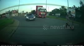 A man on Electric scooter filters through traffic on a busy roundabout and rides at 50mph dancing and indicating turns with his legs.